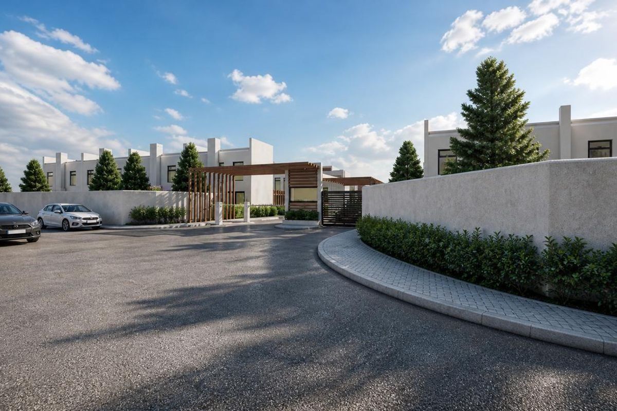 A modern residential estate entrance featuring a paved driveway, perimeter boundary walls, and a timber-slatted gate structure.
