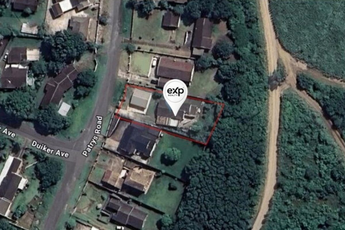 Aerial view of the property showing the house, outbuilding, and surrounding residential plot boundaries.