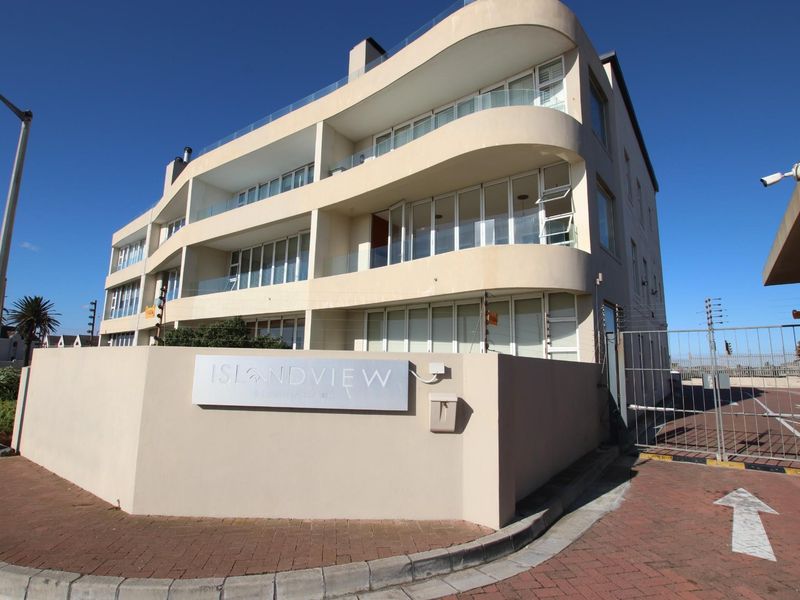 Exterior view of the Islandview apartment complex, featuring modern curved balconies, glass balustrades, and secure gated entrance.