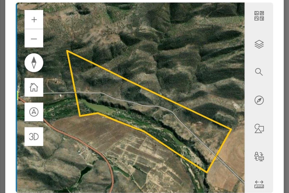 Aerial view of the farm property showing the land boundaries, surrounding landscape, and access road.