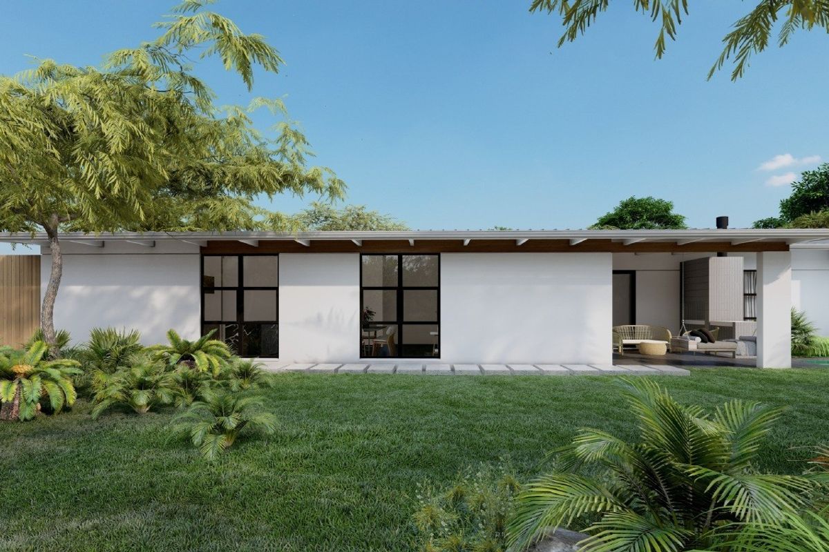 A modern rear exterior view featuring a clean white facade, black-framed windows, exposed timber rafters, and a covered patio overlooking a landscaped garden.