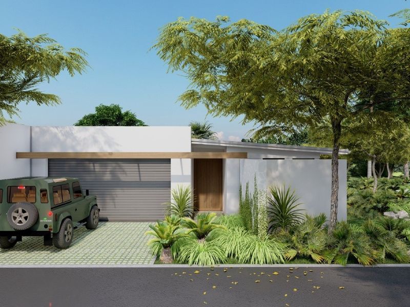 Modern single-story residential facade featuring a clean white finish, integrated garage, timber entrance door, and landscaped front garden.