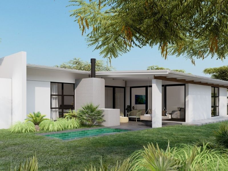 Rear exterior view featuring a modern covered patio, outdoor fireplace, and a swimming pool set within a landscaped garden.