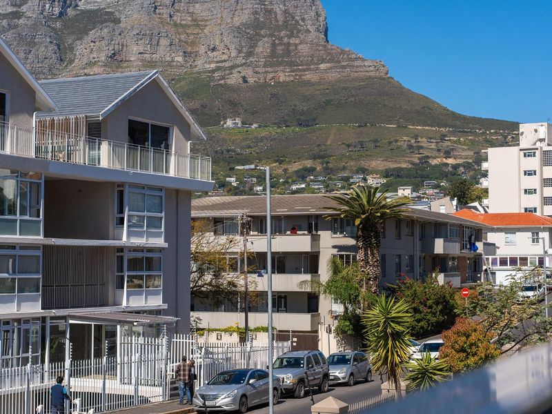 An elevated view of the apartment complex exterior featuring mountain vistas and surrounding residential streetscape.