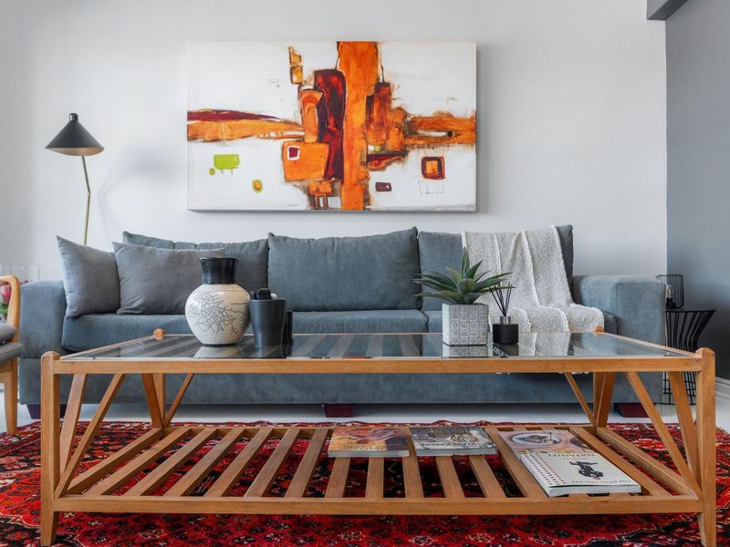 A well-maintained living room featuring neutral wall finishes and a clean, modern aesthetic.