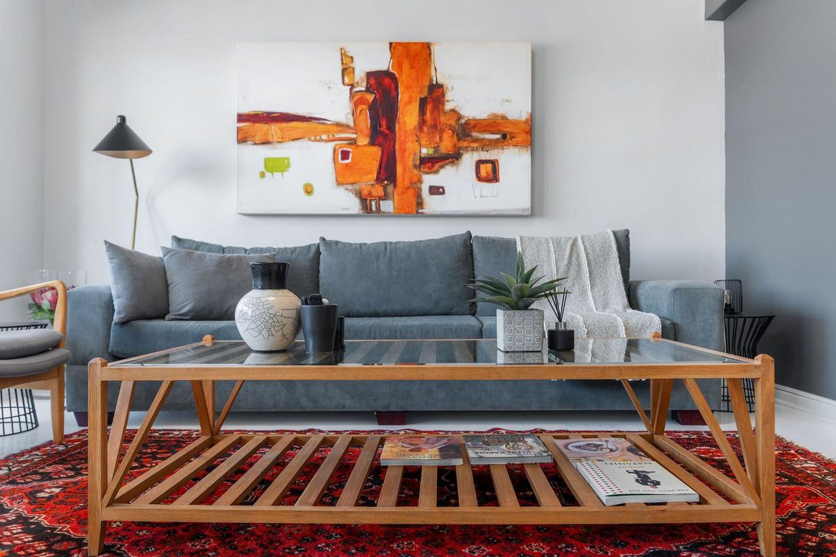 A well-maintained living room featuring neutral wall finishes and a clean, modern aesthetic.