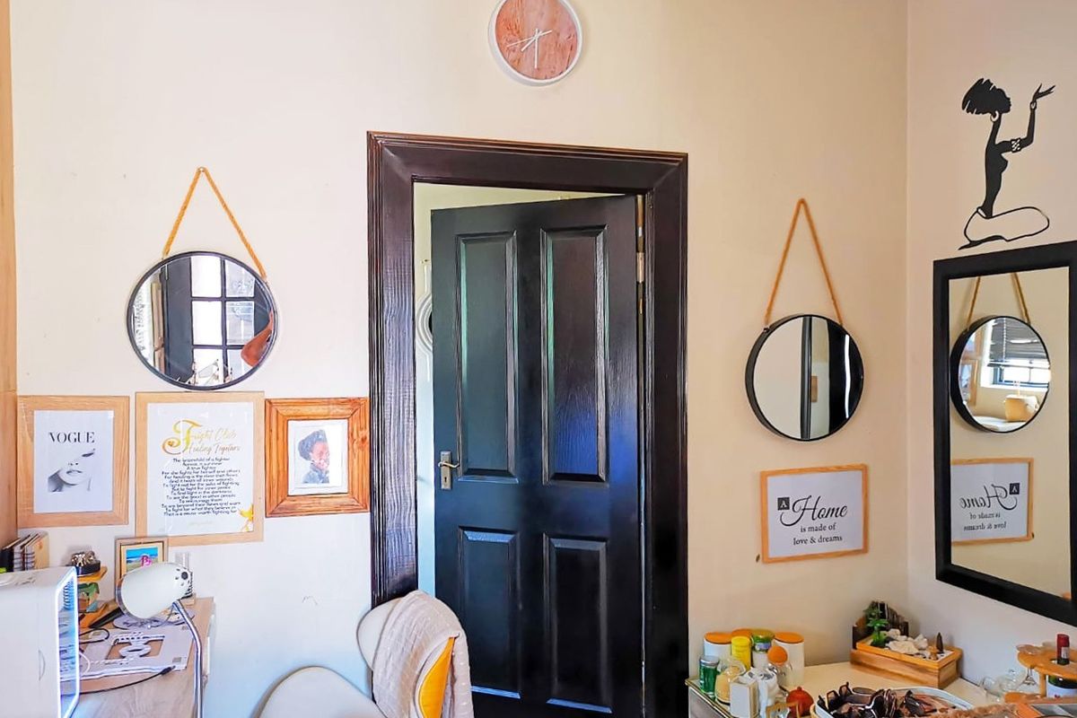 Interior view of a room featuring a dark-stained timber door frame and door, providing access to an adjacent space.