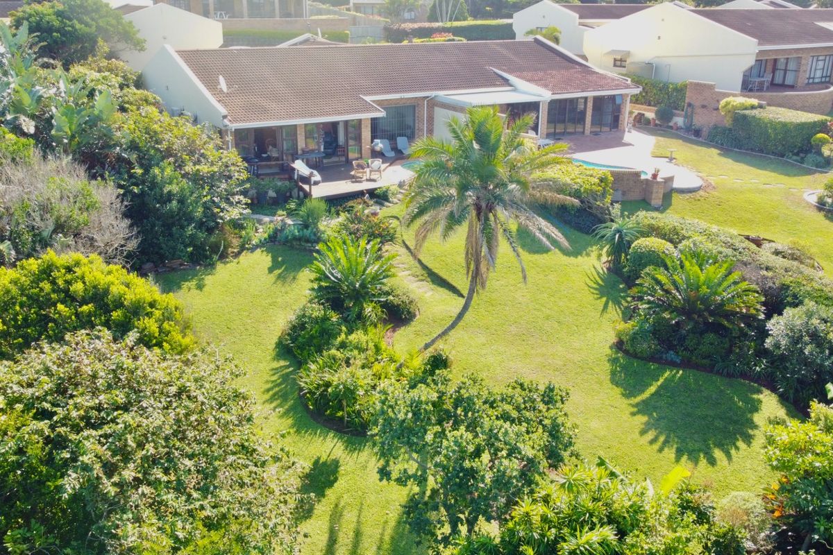 Aerial view of the townhouse property featuring a spacious rear garden, swimming pool, and a covered patio area.