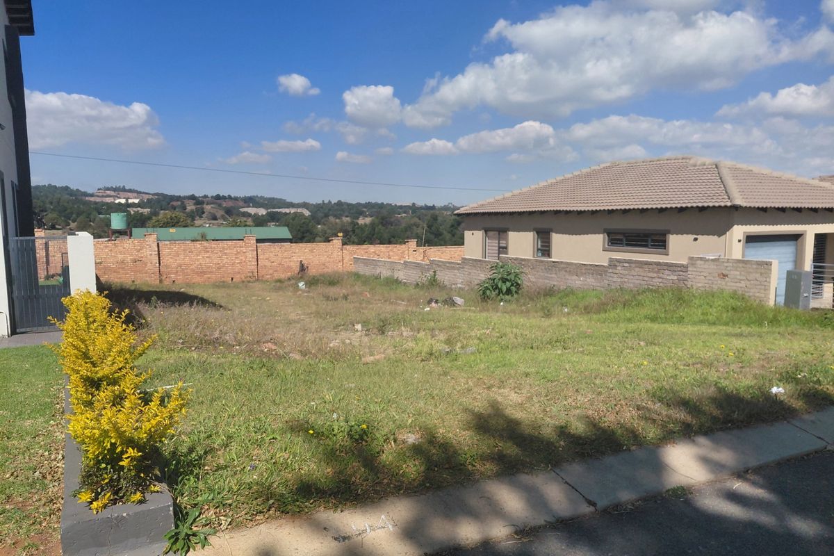 A vacant residential plot featuring established perimeter brick walling and surrounding neighborhood views, ready for development.