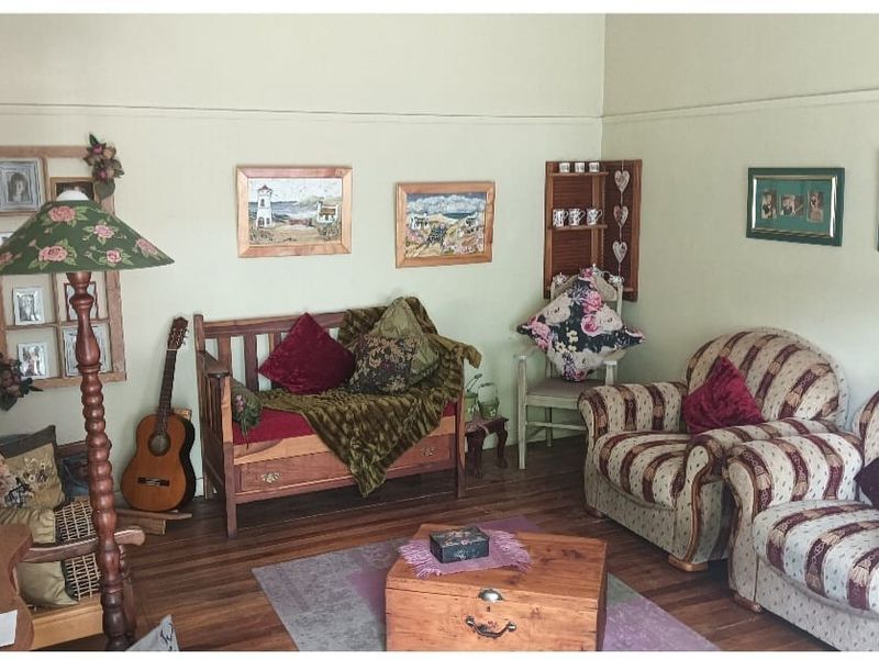 A cozy living room featuring original timber flooring and picture rails, providing a classic foundation for comfortable living.
