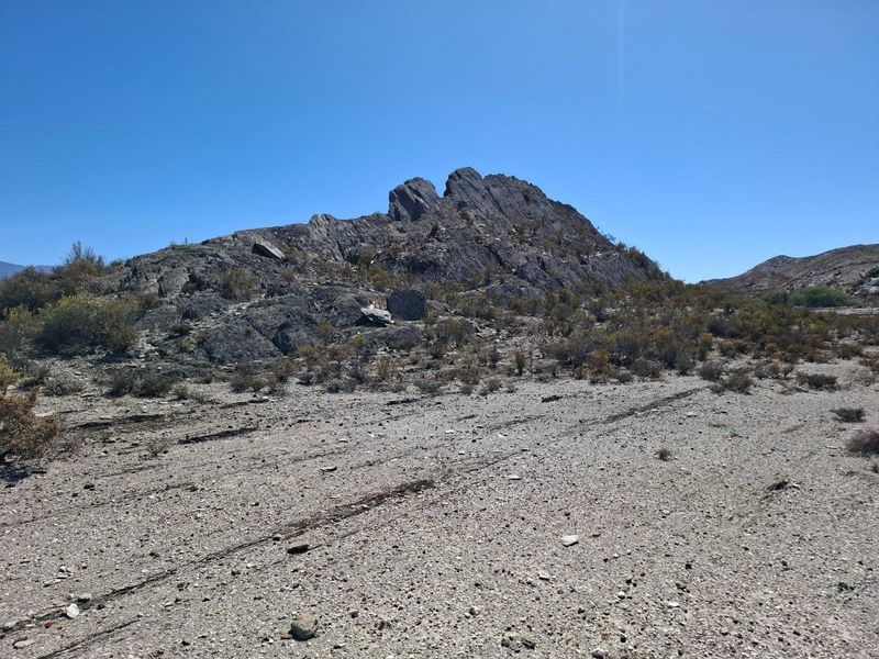 A scenic view of a natural rocky outcrop and arid landscape characteristic of the farm property.