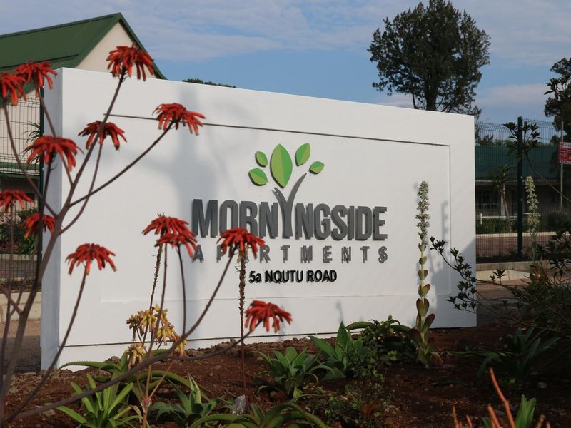 The entrance signage for Morningside Apartments located at 5a Nqutu Road, featuring a clean, modern boundary wall and landscaped garden area.