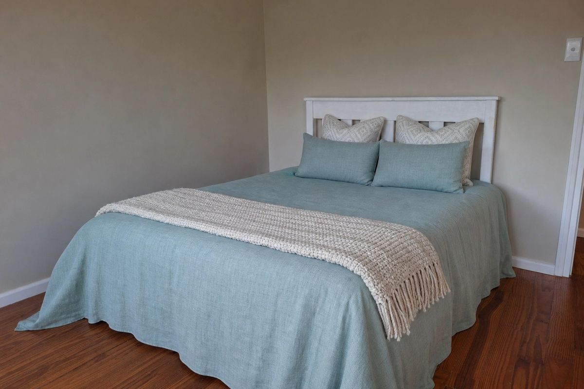 A well-maintained bedroom featuring warm-toned timber flooring and neutral wall finishes.