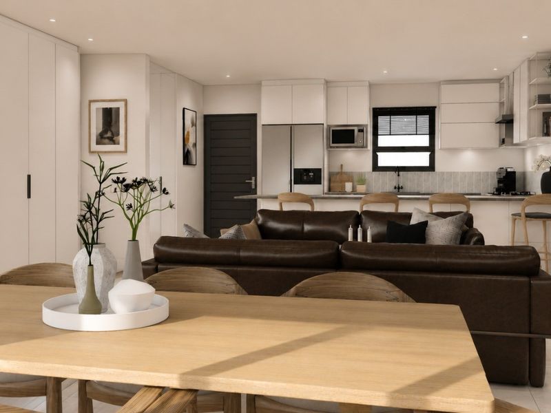 Modern open-plan living area featuring a sleek kitchen with built-in cabinetry, island, and integrated appliances, seamlessly flowing into the dining and lounge space.