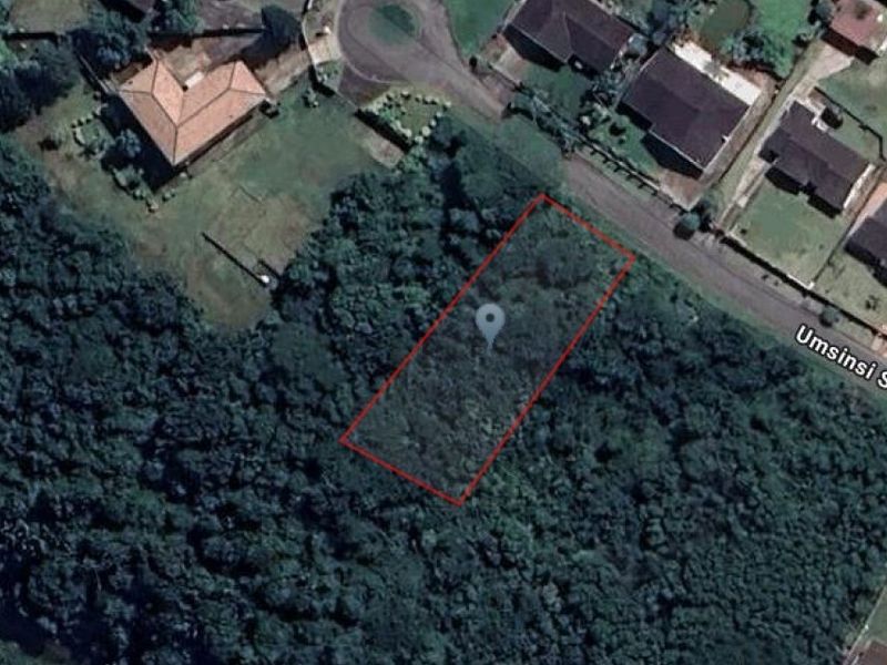 Aerial view of a vacant residential plot surrounded by dense vegetation, located along Umsinsi Street.