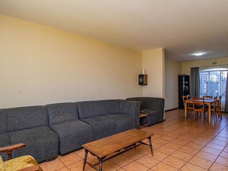 Open-plan living and dining area featuring ceramic tile flooring and neutral wall finishes, providing a functional space for daily living and entertaining.