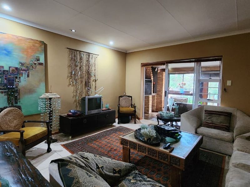 Spacious living room featuring recessed ceiling lighting and sliding glass doors providing direct access to an outdoor patio area.
