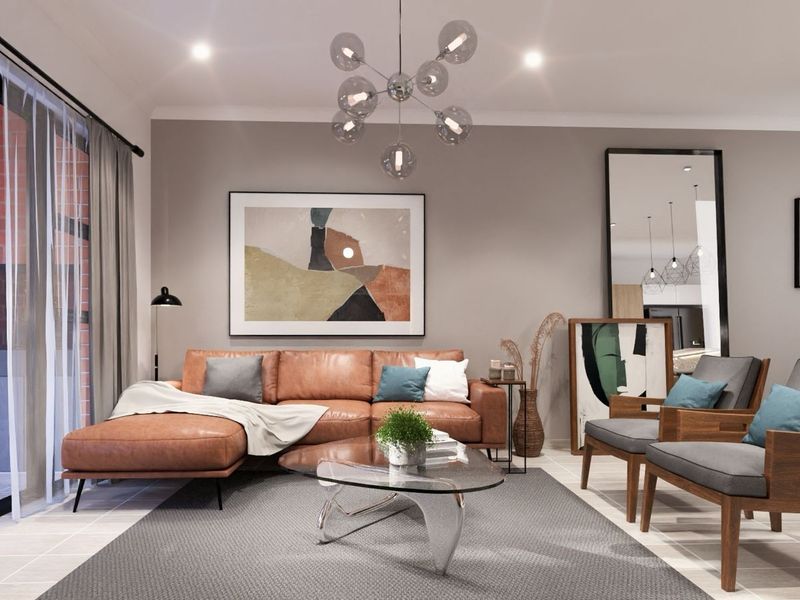 A modern, well-lit open plan living area featuring large sliding glass doors that provide seamless access to an outdoor patio space.