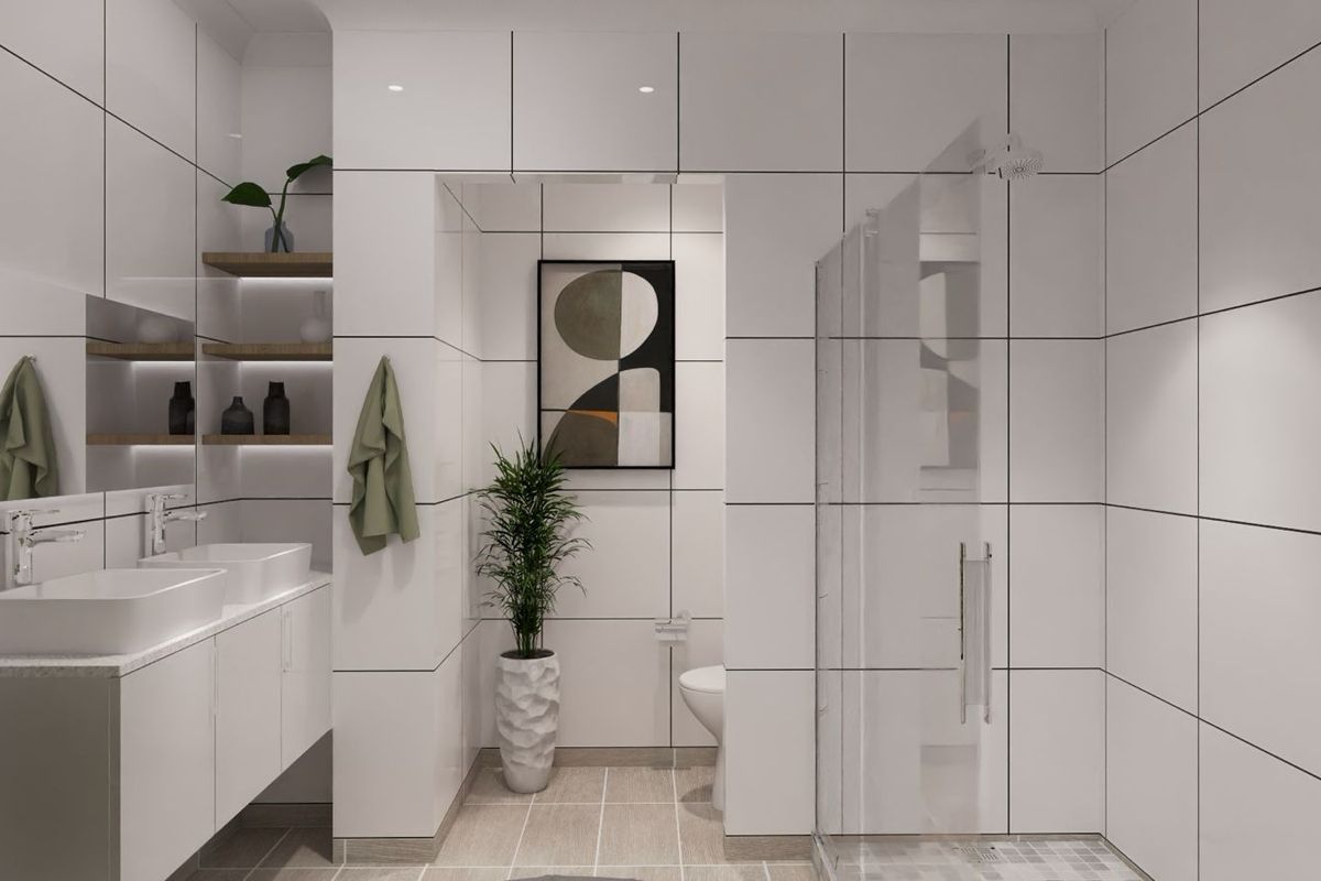 Modern bathroom featuring a double vanity with integrated sinks, a glass-enclosed walk-in shower, and contemporary white wall tiling with dark grout lines.