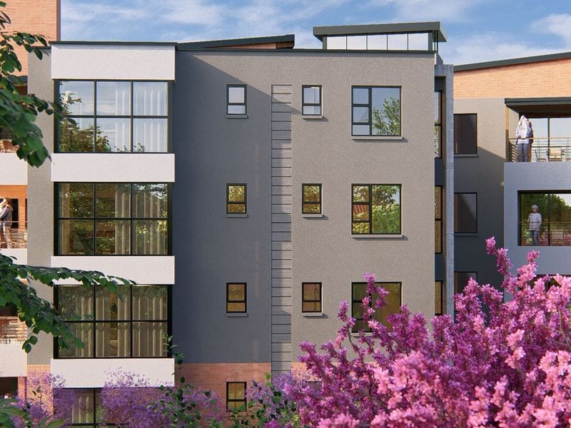 A modern multi-story apartment building facade featuring contemporary grey and brick finishes, large windows, and private balconies.