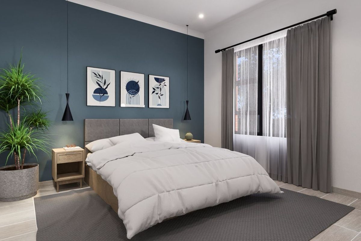 A modern bedroom featuring a blue accent wall, tiled flooring, and large windows with curtains, creating a bright and comfortable living space.
