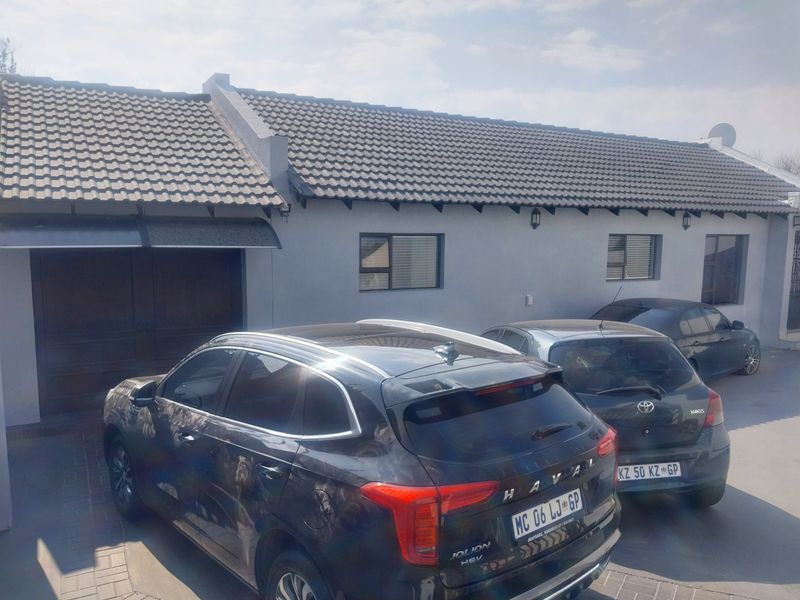 Front exterior view of the property featuring a tiled roof, paved driveway, and integrated garage access.