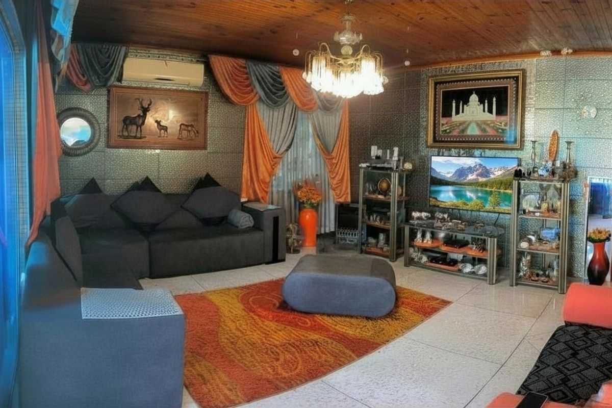 Spacious living room featuring tiled flooring, a timber-paneled ceiling, and wall-mounted air conditioning unit.