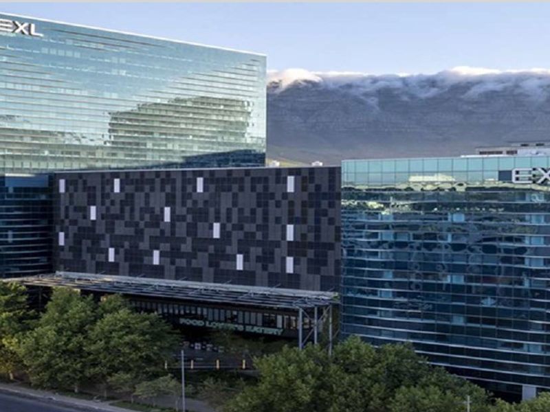Modern glass-facade office complex featuring large corporate buildings with mountain views in a prominent urban location.