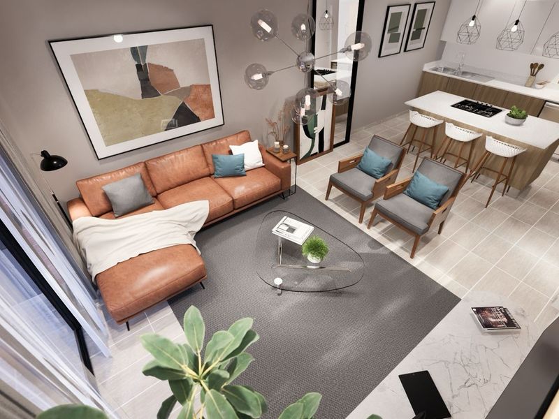 Modern open-plan living area featuring a sleek kitchen with a central island, breakfast bar, and contemporary finishes in a bright, well-designed apartment layout.