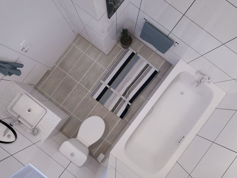 A modern, well-appointed bathroom featuring a white bathtub, a vanity basin with stone countertop, and a toilet, finished with clean white wall tiles.