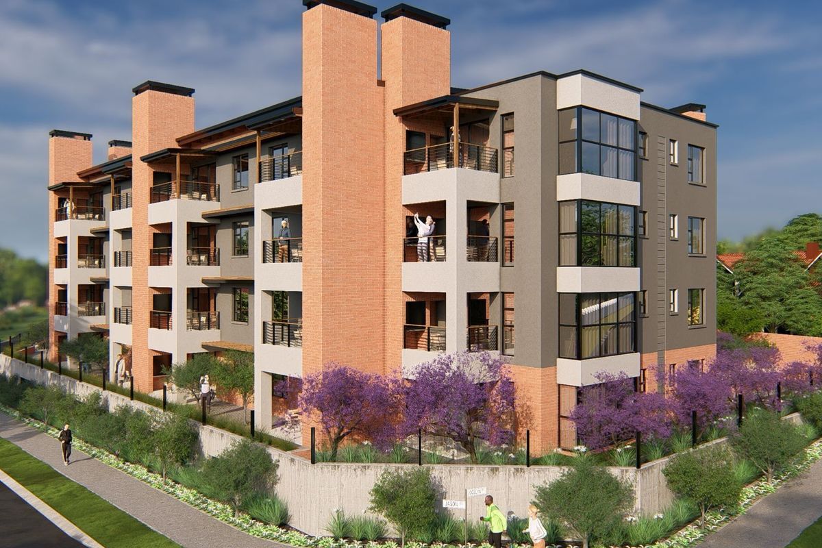 A modern multi-story apartment building featuring brick and rendered facades, private balconies, and landscaped perimeter gardens in a contemporary residential setting.
