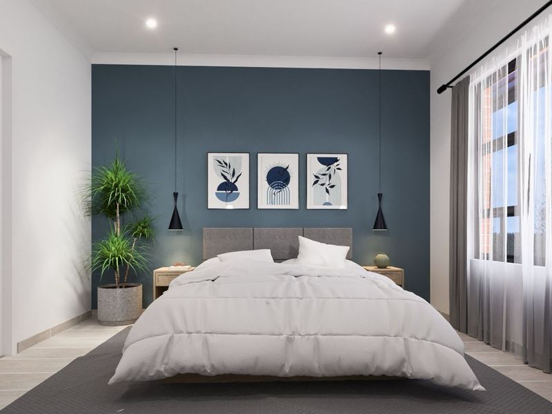 A modern, well-lit bedroom featuring a striking dark blue accent wall, recessed downlighting, and large windows with neutral curtains.