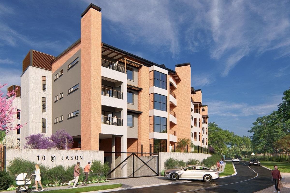 A modern multi-story apartment complex featuring brick and concrete facade elements, balconies, and secure gated entrance.