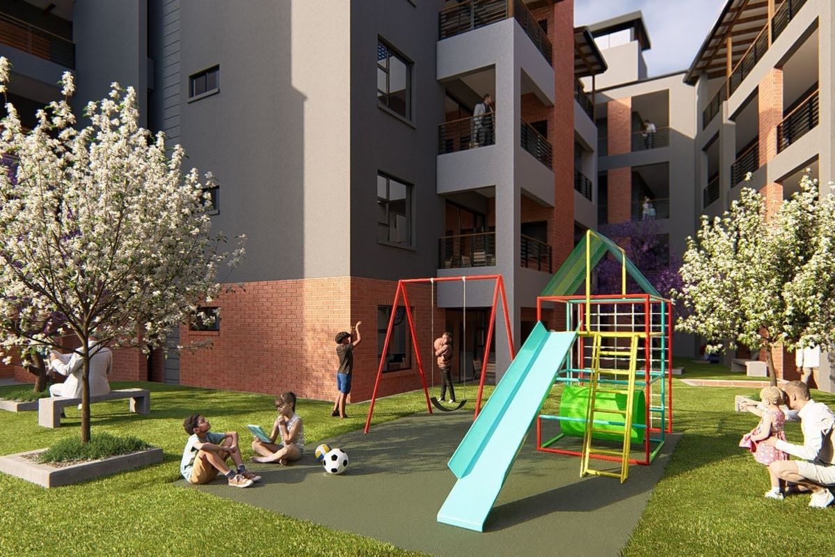 A modern apartment complex courtyard featuring a landscaped garden, paved play area with a jungle gym and swing set, and multi-story residential building facades.