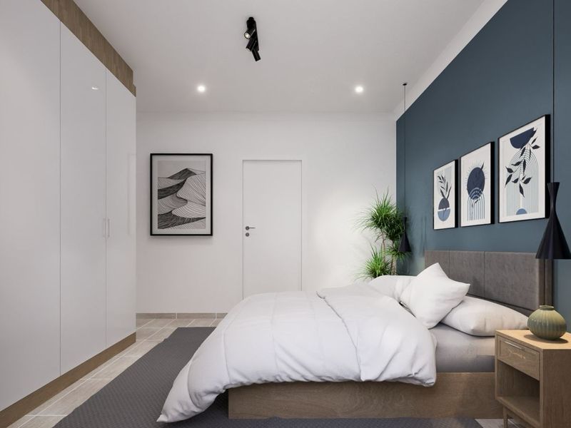 A modern bedroom featuring built-in floor-to-ceiling wardrobes, a feature wall, and recessed downlighting.