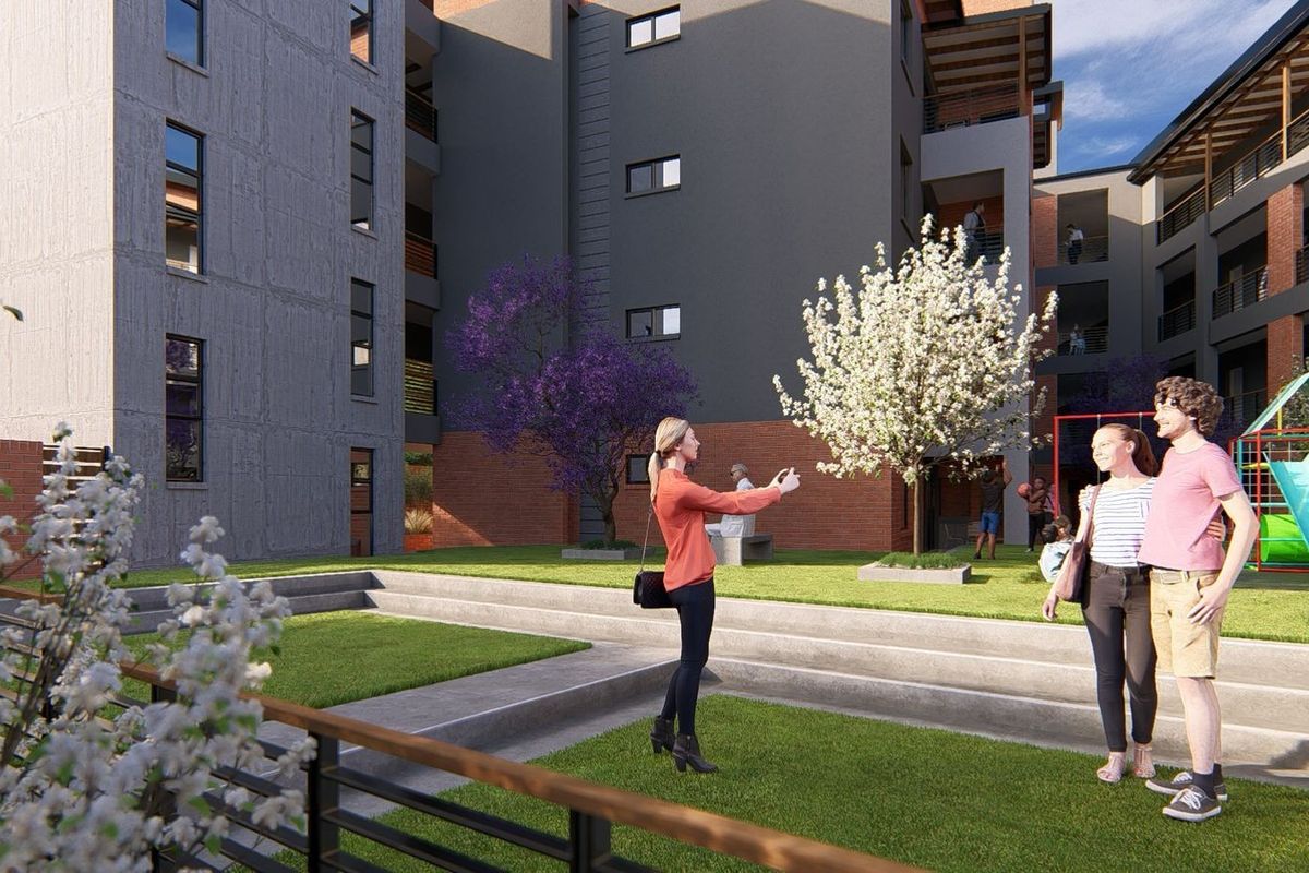 A modern apartment complex courtyard featuring landscaped tiered lawns, paved walkways, and integrated recreational play areas for residents.