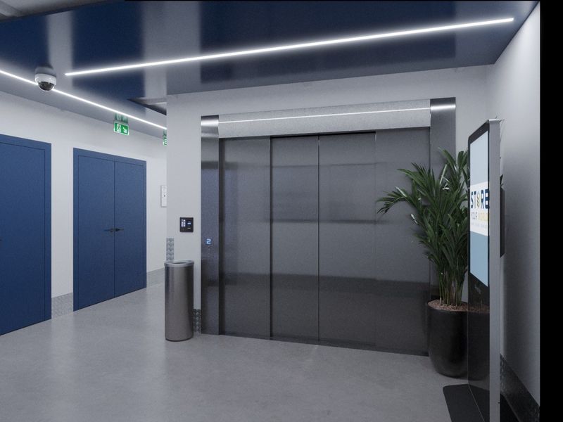 Modern commercial elevator lobby featuring sleek metallic doors, recessed linear ceiling lighting, security camera, and blue accent doors in a clean, professional environment.
