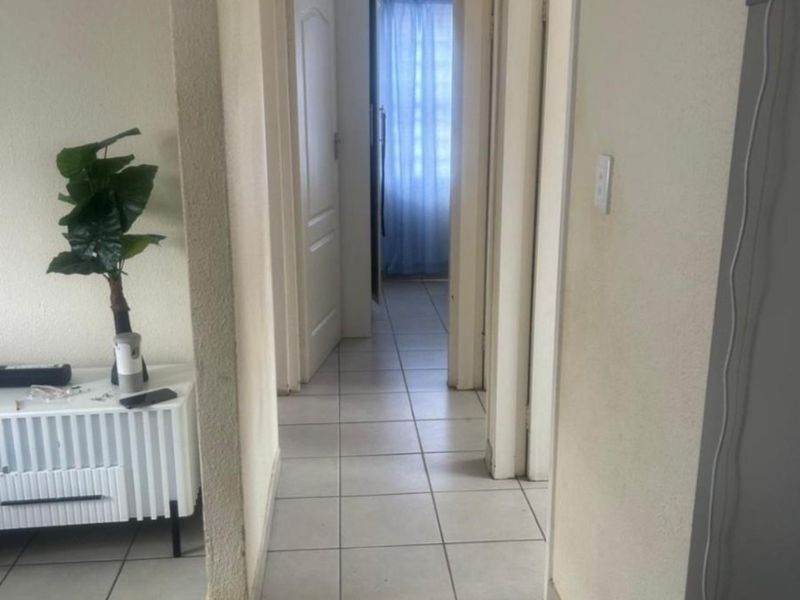 A functional hallway featuring tiled flooring and access to multiple rooms, providing a central circulation space within the home.