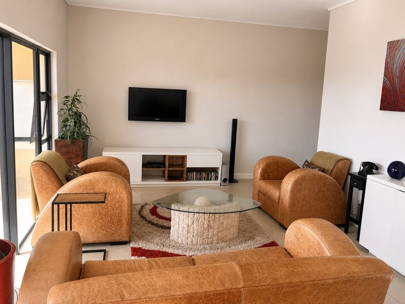 A bright and spacious living room featuring large sliding glass doors that provide access to an outdoor area and ample natural light.