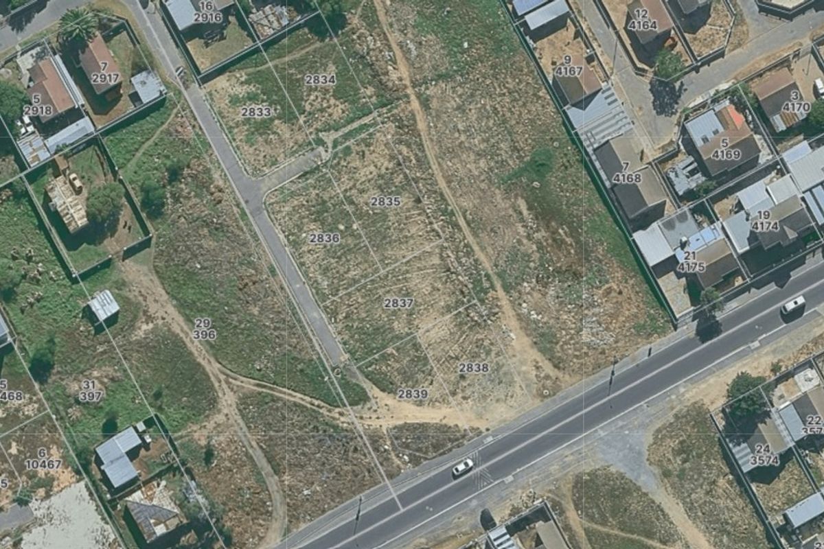 Aerial view of vacant residential land plots in a suburban neighborhood, showing site boundaries and surrounding road infrastructure.