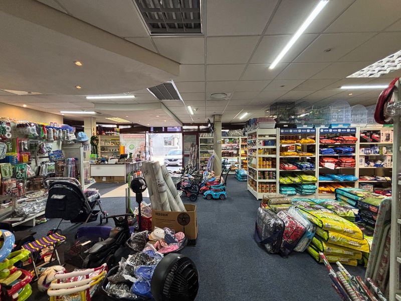 Spacious retail interior featuring a suspended ceiling with integrated lighting, air conditioning vents, and a functional service counter area.