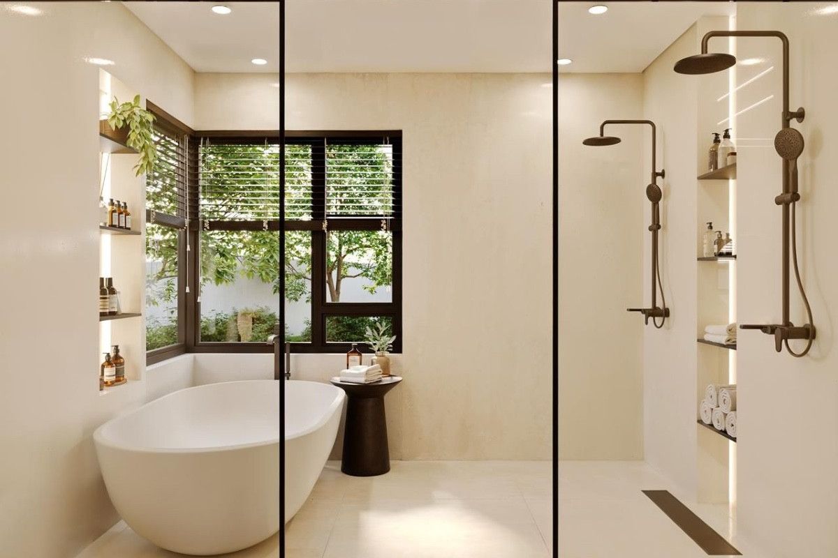 Modern bathroom featuring a freestanding soaking tub, a spacious walk-in shower with dual showerheads, and integrated recessed shelving with ambient lighting.