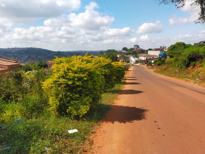 A view of the local street and surrounding neighbourhood landscape, showing the road approach and nearby residential properties.