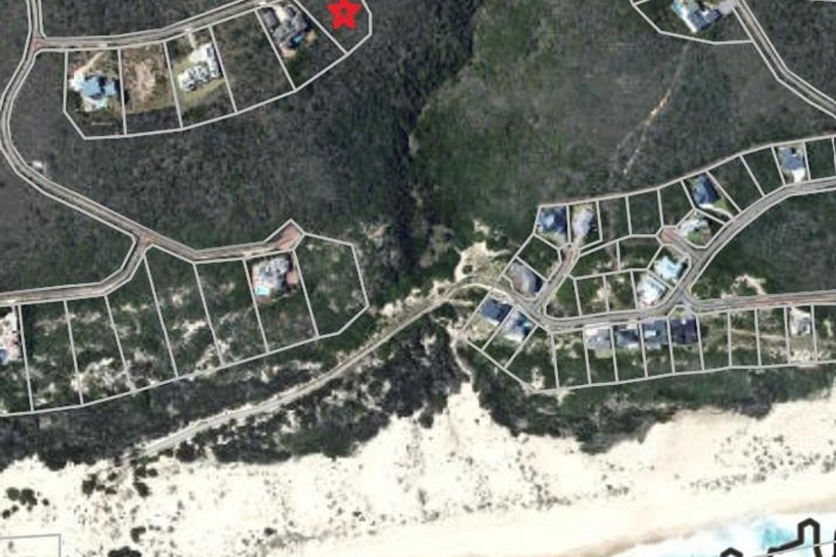 Aerial view of a residential land parcel within a coastal estate, showing the property boundaries and surrounding landscape.