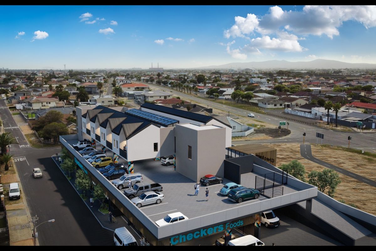An aerial view of a modern apartment complex featuring a rooftop parking area and ground-level commercial space.