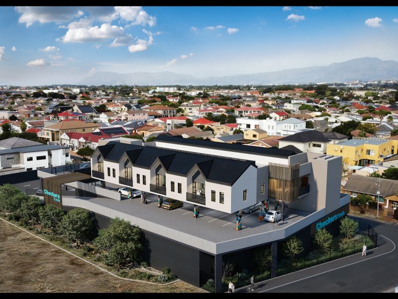 An aerial perspective of a modern apartment complex featuring contemporary architectural design, integrated parking facilities, and a prominent commercial ground-floor presence.