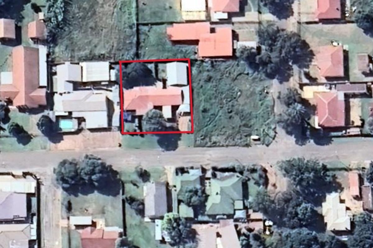 Aerial view of the residential property highlighting the building footprint and surrounding plot layout within the neighborhood.