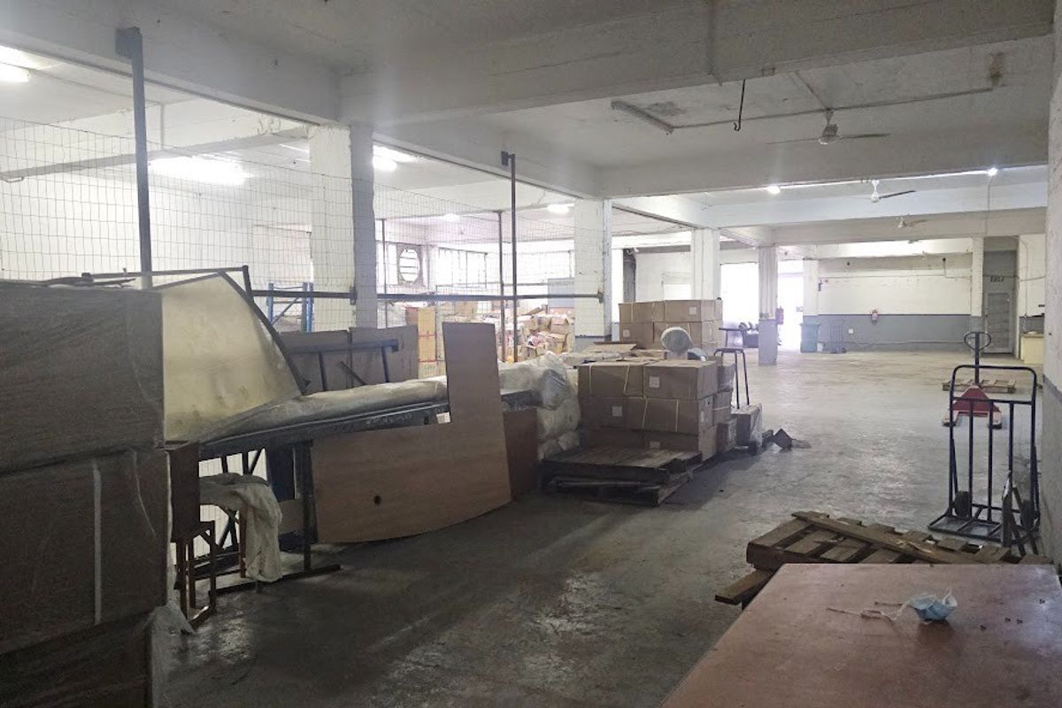 Spacious industrial warehouse area featuring high ceilings, concrete flooring, and open-plan layout suitable for storage or manufacturing operations.