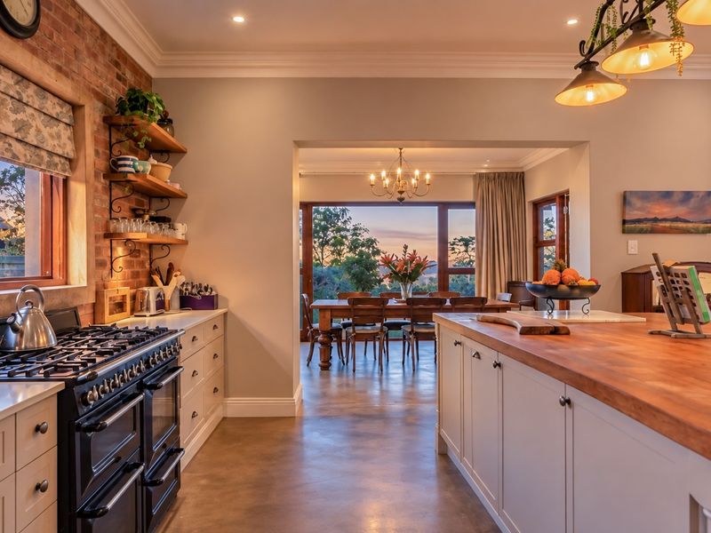 Spacious open-plan kitchen featuring an exposed brick wall, large island with butcher block countertop, gas range, and seamless flow to the dining area.