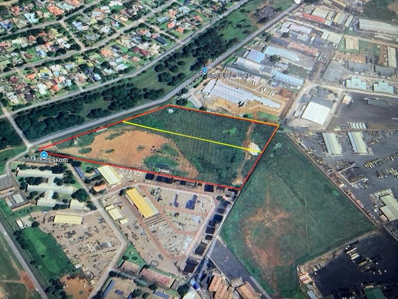 Aerial view of a large industrial land parcel with clear boundary demarcations, situated in an established industrial zone.